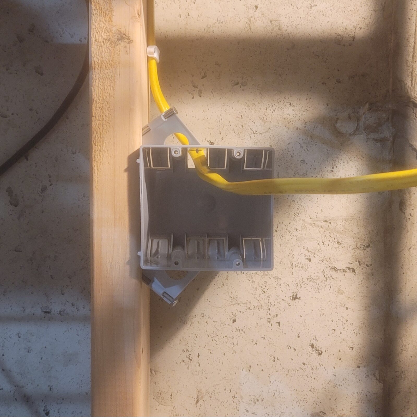 Bottom two gang box on a stud, yellow cable coming down from the top box